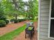Landscaped backyard with a mix of green grass, plants, and a walkway at 2948 Goldfinch Cir, Marietta, GA 30066