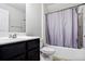 Well-lit bathroom featuring a dark vanity and shower with gray curtain at 2948 Goldfinch Cir, Marietta, GA 30066
