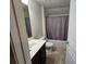 A simple bathroom features a tub with shower, a toilet, and a vanity at 2948 Goldfinch Cir, Marietta, GA 30066