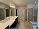 Bright bathroom features double sinks, a large mirror, and tiled shower with glass doors at 2948 Goldfinch Cir, Marietta, GA 30066