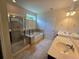 Bathroom featuring tile floors, double sink vanity, a tub, and a separate glass shower at 2948 Goldfinch Cir, Marietta, GA 30066