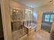 This bathroom showcases a glass-door shower, a soaking tub and access to the bedroom at 2948 Goldfinch Cir, Marietta, GA 30066