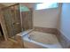 Modern bathroom featuring a tub with tile surround and a glass-enclosed shower at 2948 Goldfinch Cir, Marietta, GA 30066