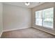 Neutral bedroom featuring wall-to-wall carpeting, a ceiling fan, and large window with natural light at 2948 Goldfinch Cir, Marietta, GA 30066