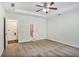 Spacious bedroom featuring wall-to-wall carpeting, a ceiling fan, and an adjoining laundry and bath at 2948 Goldfinch Cir, Marietta, GA 30066