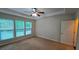 A bright bedroom with ceiling fan, large windows, and neutral carpet at 2948 Goldfinch Cir, Marietta, GA 30066