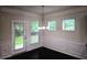 Bright dining room with modern chandelier, dark wood floor, wainscotting and large windows that let in lots of light at 2948 Goldfinch Cir, Marietta, GA 30066