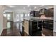 Modern kitchen with dark cabinets, stainless steel appliances, island, open to living area, hardwood floors at 2948 Goldfinch Cir, Marietta, GA 30066