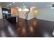 Open-concept living room and kitchen featuring hardwood floors and modern lighting fixtures at 2948 Goldfinch Cir, Marietta, GA 30066