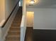 View of the carpeted staircase leading to the second floor and hallway with dark wood floor at 2948 Goldfinch Cir, Marietta, GA 30066
