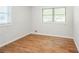 Cozy bedroom with two windows and hardwood floors at 1526 Tanglewood Nw Way, Conyers, GA 30012