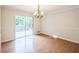 Bright dining room with wood floors, a slider to the backyard deck, and neutral decor at 1526 Tanglewood Nw Way, Conyers, GA 30012