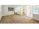 Open living room featuring carpet, seamlessly connecting the kitchen and dining areas with natural light at 1526 Tanglewood Nw Way, Conyers, GA 30012
