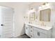 Bright bathroom featuring double vanity with brass hardware, and gold framed mirrors at 160 Winner St, Acworth, GA 30102