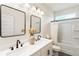 Bathroom featuring double vanity with dark fixtures and a shower-tub combo at 160 Winner St, Acworth, GA 30102