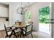 Cozy dining area with modern lighting, backyard view, and seating for four at 160 Winner St, Acworth, GA 30102