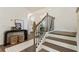 Beautiful entryway featuring hardwood stairs, elegant railing, and stylish console table with decor at 160 Winner St, Acworth, GA 30102