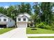 Charming two-story home with a manicured lawn, driveway, and attached garage at 160 Winner St, Acworth, GA 30102