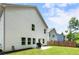 A charming two-story white home with a grill on a concrete pad and a green backyard at 160 Winner St, Acworth, GA 30102