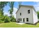 A charming two-story white home with a grill on a concrete pad in a green backyard at 160 Winner St, Acworth, GA 30102