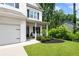 Home featuring a meticulously landscaped front yard, covered porch, and an attached garage at 160 Winner St, Acworth, GA 30102