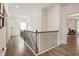 Hallway features hardwood floors, natural light, black wrought iron railing, and multiple doorways at 160 Winner St, Acworth, GA 30102