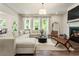 Bright living room featuring fireplace, large windows, and comfortable sectional seating at 160 Winner St, Acworth, GA 30102