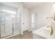 Modern main bathroom featuring a glass-enclosed shower, dual vanities with quartz countertops, and tile floor at 160 Winner St, Acworth, GA 30102