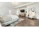 Bright main bedroom with a tray ceiling, chandelier, and sitting area with modern decor at 160 Winner St, Acworth, GA 30102