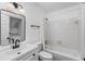 Modern bathroom featuring a stylish vanity, black fixtures, and a convenient washer/dryer combo in the mirror's reflection at 1701 Wiscasset Pl, Tucker, GA 30084