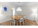 Bright dining room with modern lighting fixture and seating for six at 1701 Wiscasset Pl, Tucker, GA 30084