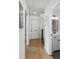 Inviting entryway with light wood floors and half bath featuring modern fixtures and white vanity at 1701 Wiscasset Pl, Tucker, GA 30084
