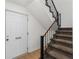 Entryway view with front door and staircase featuring neutral carpet and black metal railing at 1701 Wiscasset Pl, Tucker, GA 30084