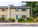 Charming two-story townhome with a well-maintained lawn and a delightful blue front door at 1701 Wiscasset Pl, Tucker, GA 30084