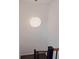 Bright hallway featuring a modern pendant light and staircase with dark banister at 1701 Wiscasset Pl, Tucker, GA 30084