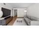 Stylish living room showcasing a large TV, modern furnishings and hardwood floors at 1701 Wiscasset Pl, Tucker, GA 30084