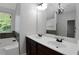 Bathroom featuring double sink vanity, tub and window view at 5123 Jack Dr, Decatur, GA 30035