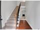 Inviting entryway featuring carpeted stairs with a wooden railing and hardwood floors at 5123 Jack Dr, Decatur, GA 30035