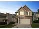 Charming two-story home with stone accents, a two-car garage and manicured lawn at dusk at 5123 Jack Dr, Decatur, GA 30035