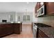 Open kitchen with granite countertops, tile flooring, and stainless gas range at 5123 Jack Dr, Decatur, GA 30035
