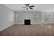 Spacious living room featuring a fireplace, neutral carpet, and ample natural light at 5123 Jack Dr, Decatur, GA 30035