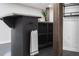 A close-up of the bar in the finished basement, featuring dark cabinets, wood column and stylish decor at 1582 Pine Cir, Austell, GA 30168