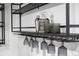 Finished basement bar with dark shelving, glassware, and whiskey accents at 1582 Pine Cir, Austell, GA 30168