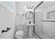 Modern basement bathroom with stand up shower, clean lines, white subway tile and sleek fixtures offers a refreshing space at 1582 Pine Cir, Austell, GA 30168