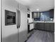 Basement kitchen features stainless steel appliances and modern tile backsplash, offering style and convenience at 1582 Pine Cir, Austell, GA 30168