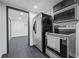 Stainless steel appliances, including a refrigerator, microwave, and oven, elevate this finished basement kitchen at 1582 Pine Cir, Austell, GA 30168