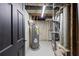 Utility basement area with water heater, HVAC system, and access door for maintenance at 1582 Pine Cir, Austell, GA 30168