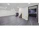 Basement with large open floor, wet bar, access to kitchen, and gray tiled floors at 1582 Pine Cir, Austell, GA 30168