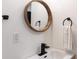 Modern bathroom with wood framed mirror, black fixtures, and a towel ring at 1582 Pine Cir, Austell, GA 30168