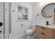 Modern bathroom with shower and tub combination with a wood vanity and bright natural light at 1582 Pine Cir, Austell, GA 30168